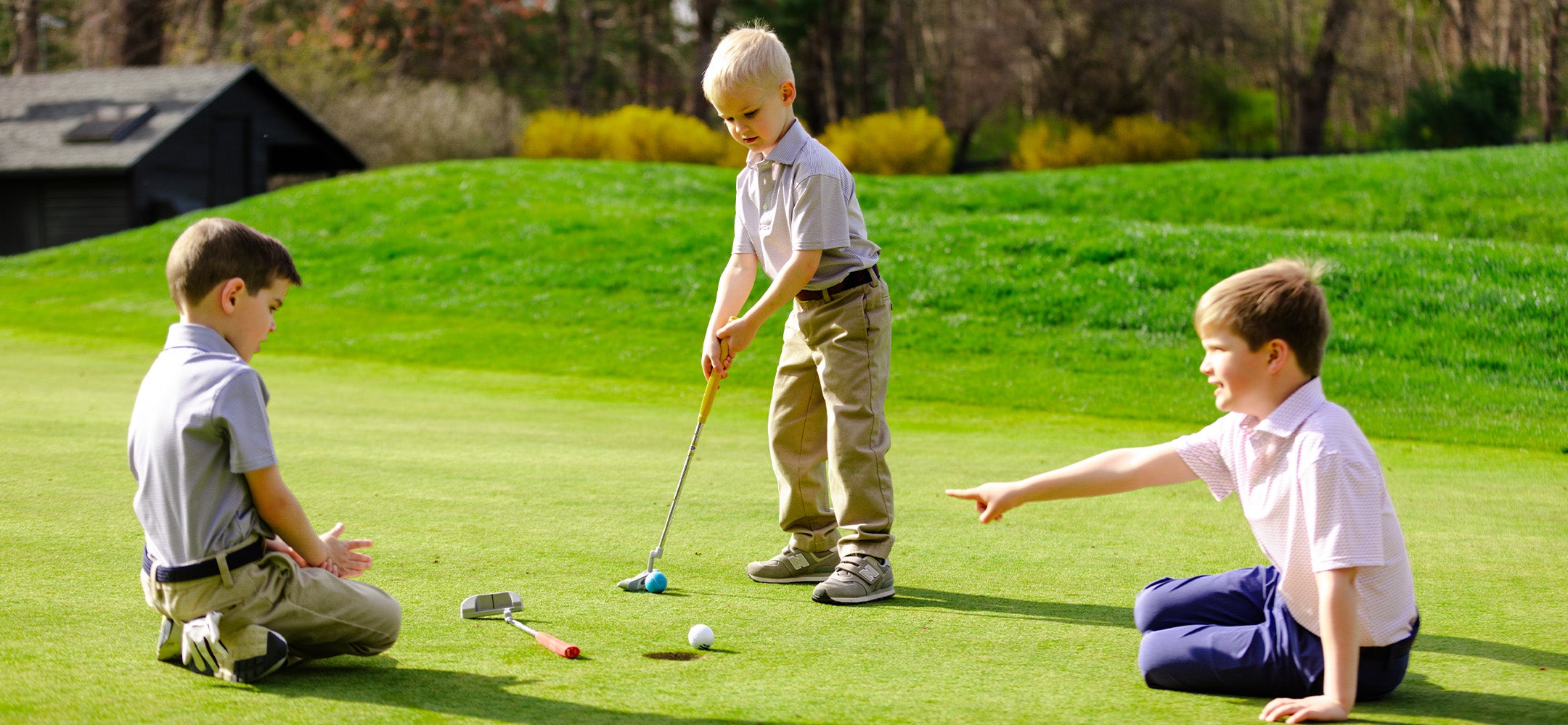 Boys wearing golf clothes playing