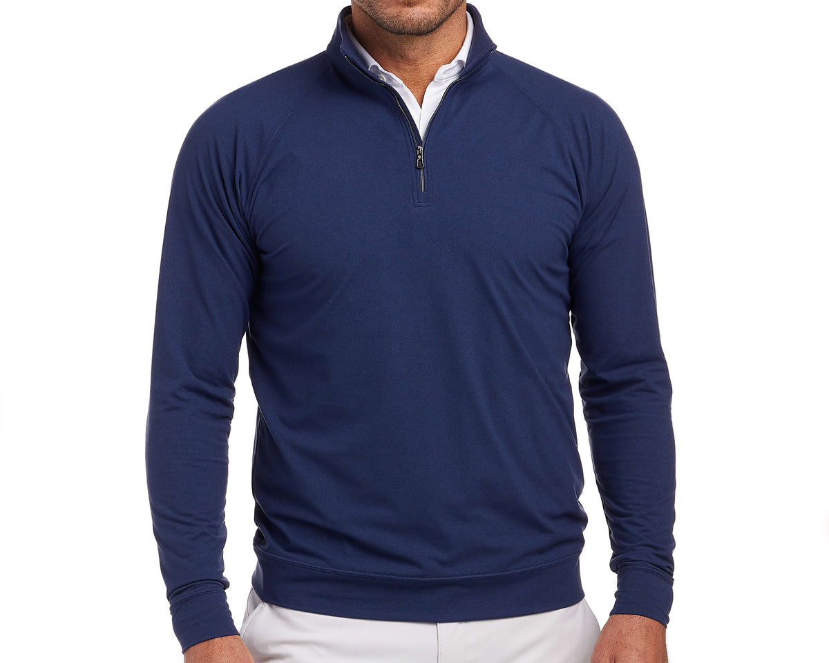 The Westland Quarter-Zip: Navy, shown layered over a white shirt with light trousers, highlights its moisture-wicking, soft peached fabric and versatile heathered design.