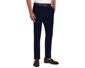 Model wearing The Anson Chino Pant: Navy, featuring slim-fit design, classic slant pockets, and paired with a black belt, white shirt, and brown loafers.