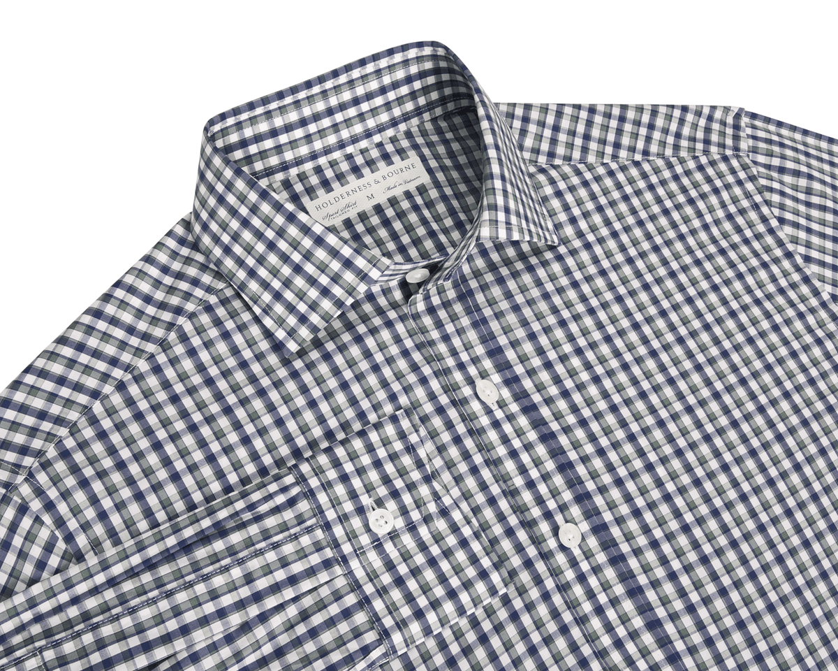 A checkered button-up shirt in green and white colors, showing the collar and part of the chest area.