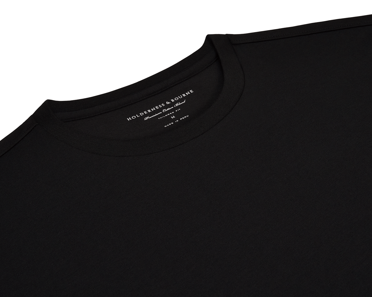 The Mason T-Shirt: Black, features a plain crew-neck design with a visible Holderness & Bourne label, highlighting its tailored fit and premium cotton blend.
