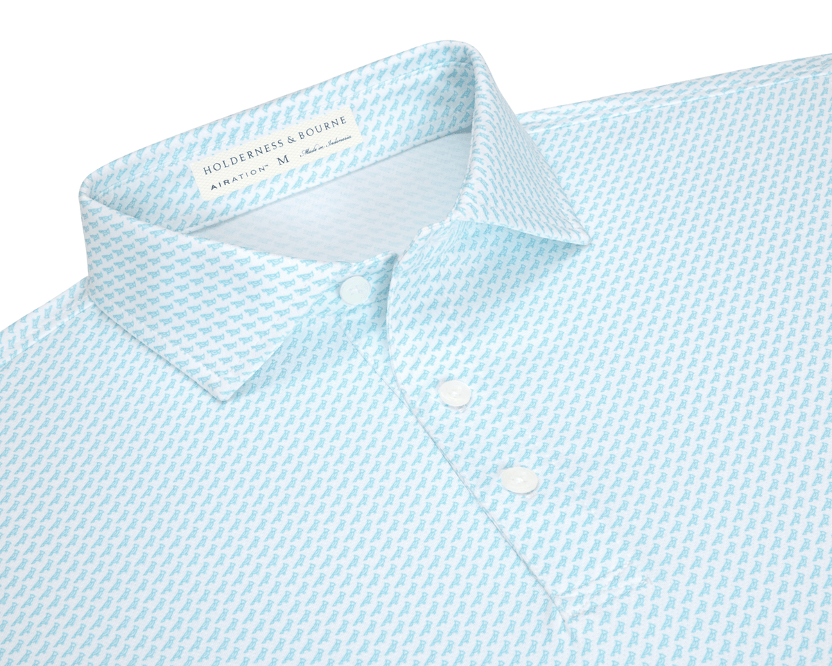 The Walton Shirt: Harbor, light blue polo with micro-pattern, spread collar, three-button placket, and Holderness & Bourne label inside, crafted from breathable AIRATION® fabric.