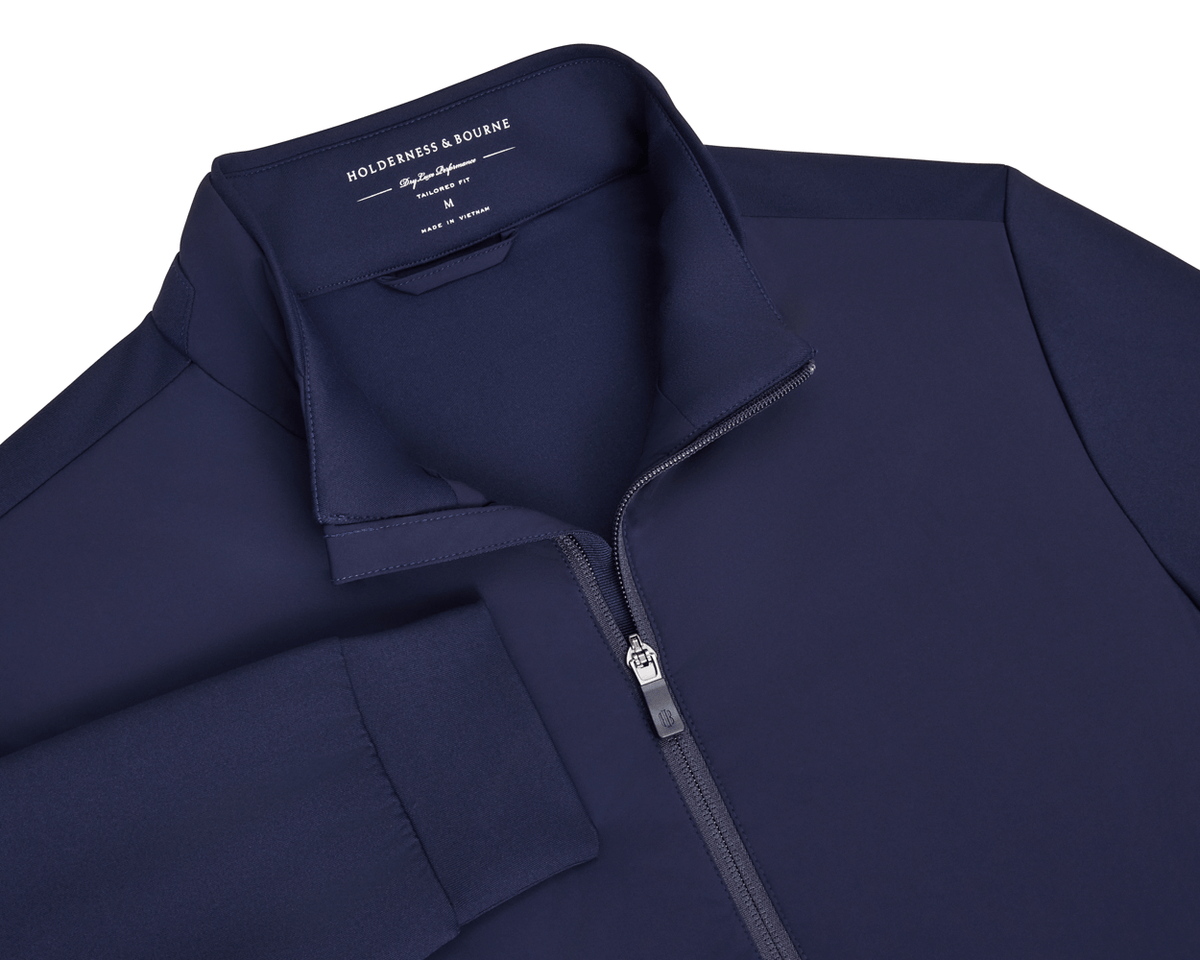 Navy blue golf jacket with a zipper on a white background