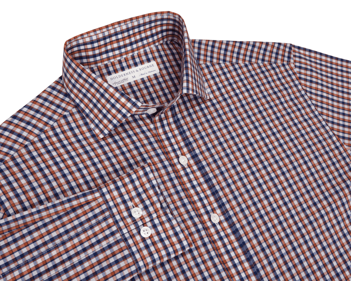 Blue and orange checkered shirt with a visible brand label on a white background