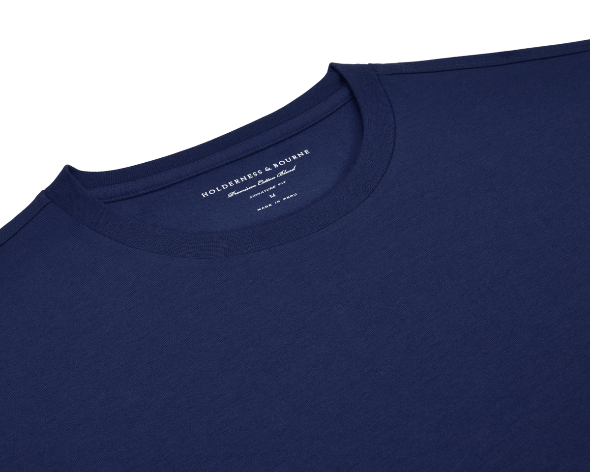 The Mason T-Shirt: Navy, a crewneck made from midweight Peruvian pima cotton blend, showcasing Holderness & Bourne branding inside the neckline. Size Medium.