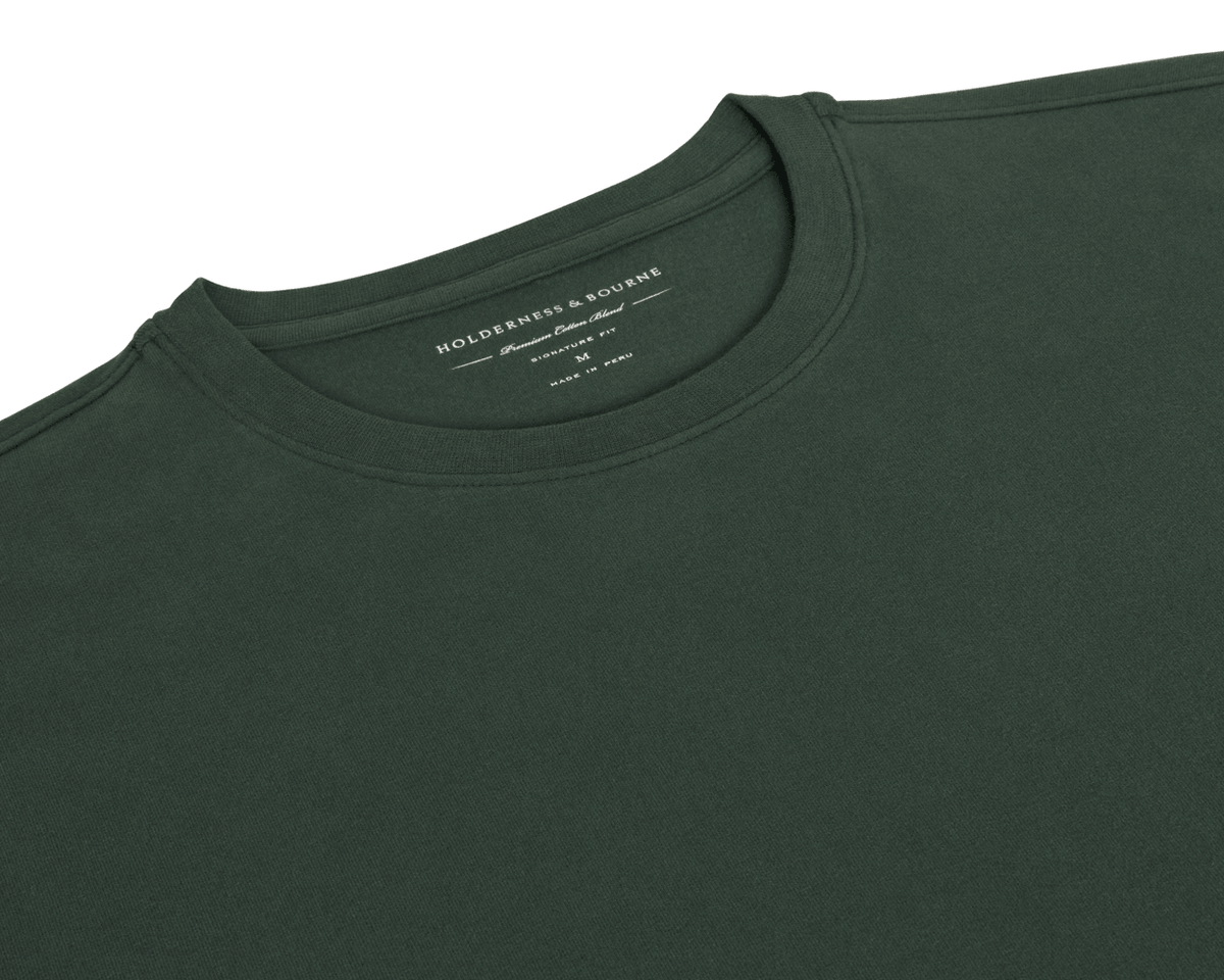 The Mason T-Shirt: Cypress flat-lay showing its ribbed crew neck and Holderness & Bourne Premium Cotton Blend label, made in Peru.