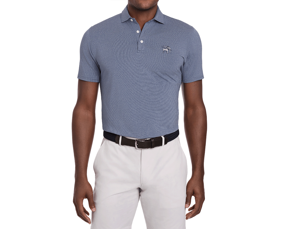 Male model in Yale Golf Course Holland Shirt: Heathered Andover, blue-and-white micro-striped polo with embroidered logo, tucked into khaki trousers, dark belt visible.