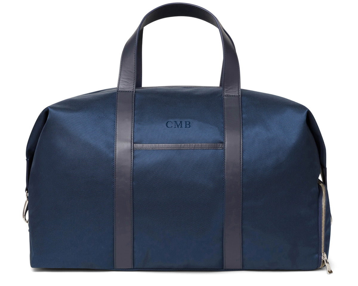 Navy ballistic luggage with dark leather straps and detailing from Holderness and Bourne.