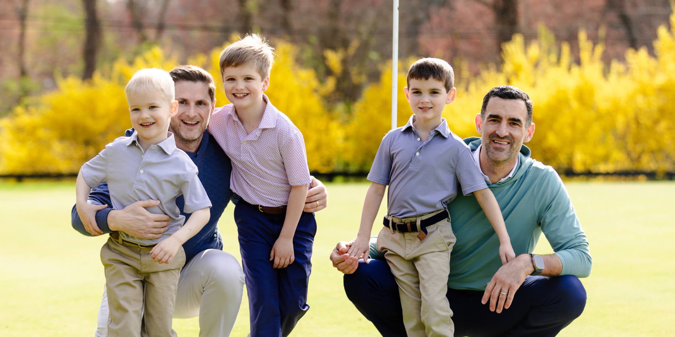 Dad with their boys wearing golf clothes