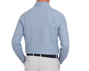 Man wearing a blue checkered shirt and light gray pants on a white background
