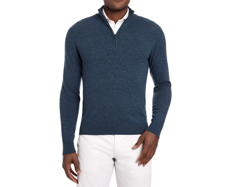 Man Holderness & Bourne Men’s Blue Quarter Zip Sweater over a white shirt with white pants on a white background