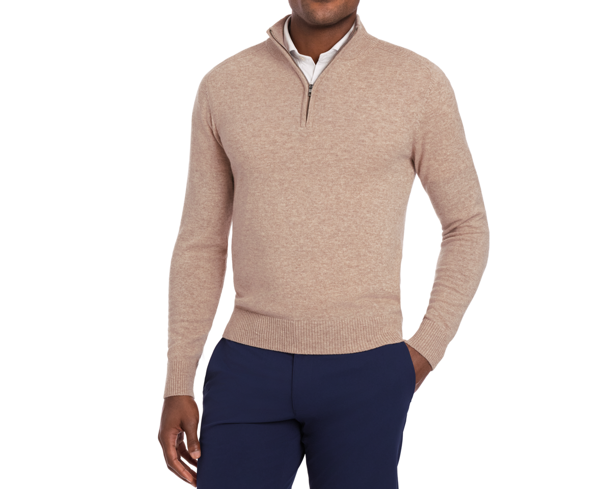 Man wearing Holderness & Bourne Men’s Tan Pullover Sweater and navy pants on a white background