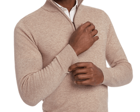Man wearing a Holderness & Bourne Men’s Tan Pullover Sweater on a white background