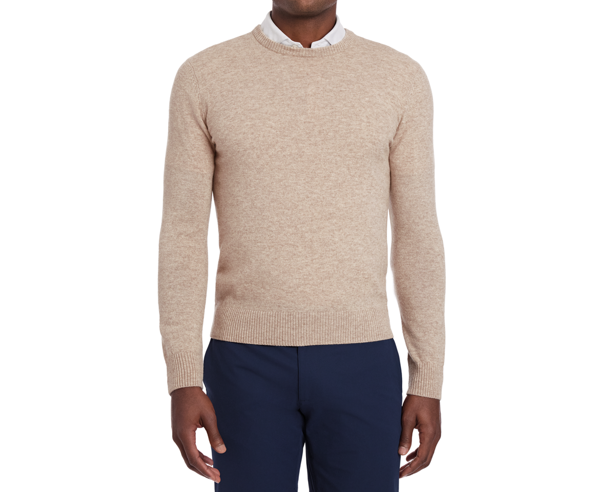 Man wearing Holderness & Bourne Men’s Beige Sweater and navy pants on a white background