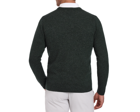 Man wearing a Holderness & Bourne Men’s Dark Green Cashmere Sweater over a white shirt on a white background