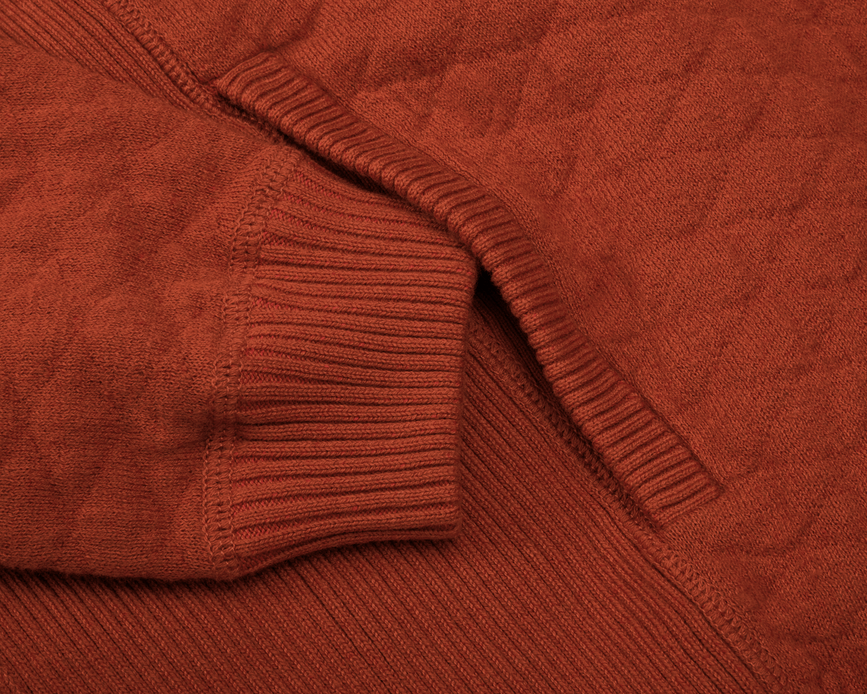 Close-up of a Holderness & Bourne Men’s Rust Sweater with a focus on texture and pattern.