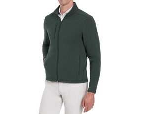 Man wearing Holderness & Bourne Men’s Dark Green Fleece Jacket over a white shirt on a white background