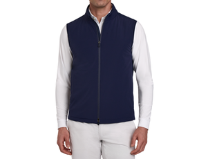 Man wearing a Holderness & Bourne Men’s Navy Blue Vest over a white shirt on a white background