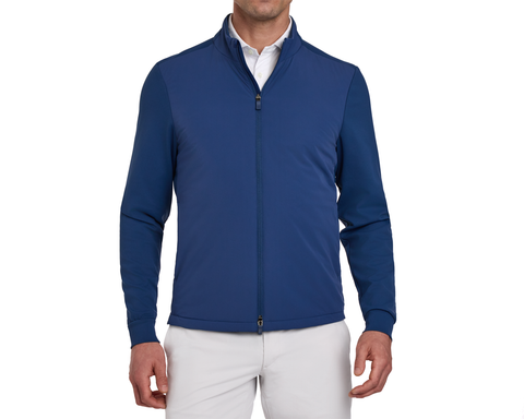 Blue golf jacket worn by a person on a white background