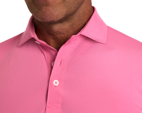 Person wearing The Anderson Shirt: Belmont, featuring a structured spread collar and undone top button, showcasing its jersey knit performance fabric for comfort and style.