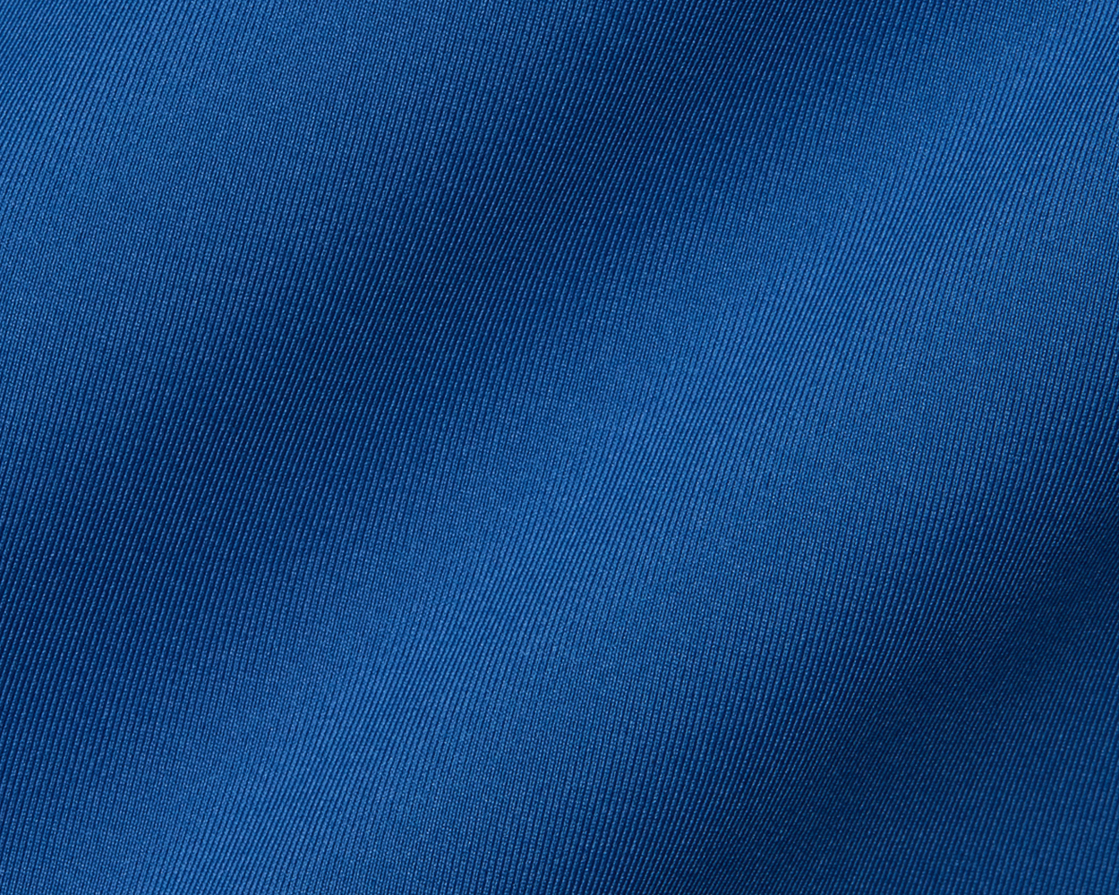 Close-up of The Anderson Shirt: Maidstone Blue, highlighting its fine diagonal weave pattern and structured spread collar, made from stretch jersey knit for comfort.