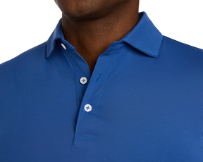 Close-up of a person wearing The Anderson Shirt: Maidstone Blue, featuring a structured collar, button placket, and crafted from stretch jersey knit for comfort.