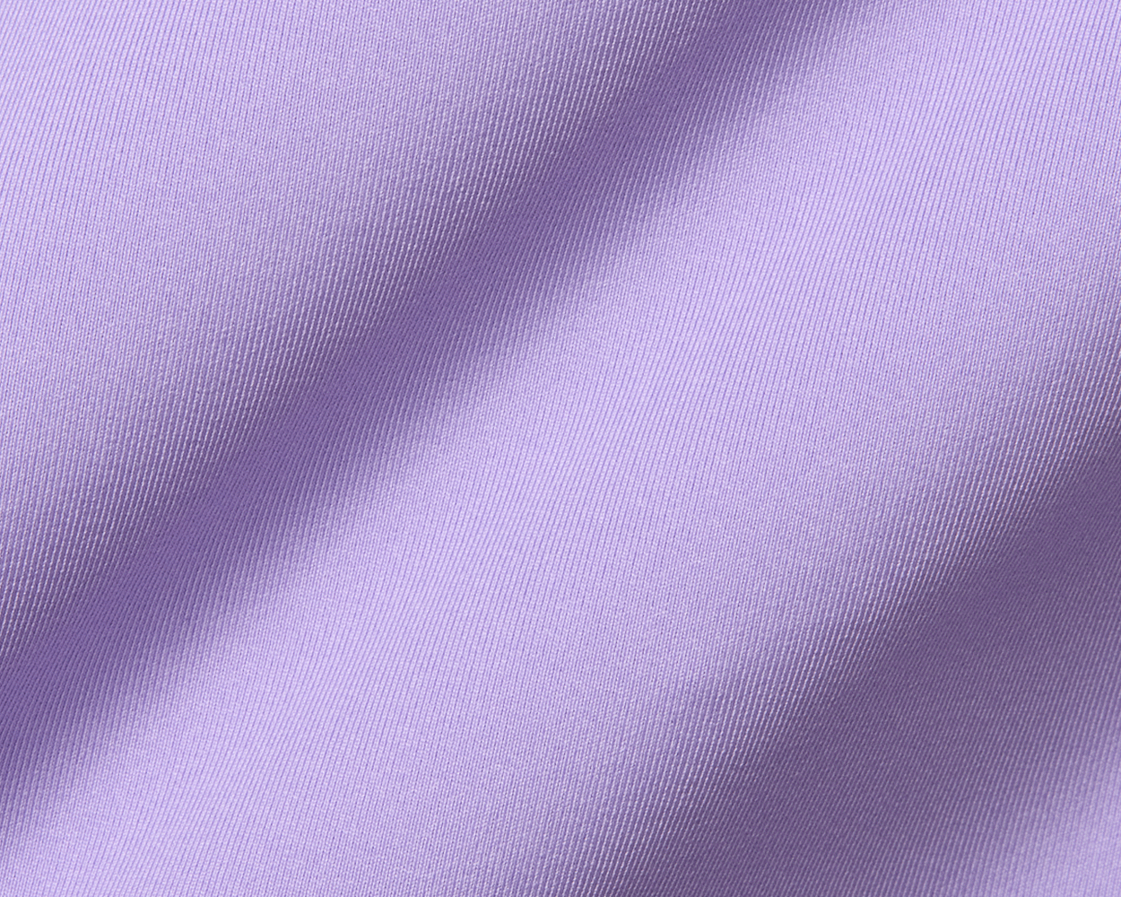 Close-up of The Anderson Shirt: Tudor, showcasing its soft lilac fabric with fine diagonal ribs, highlighting its luxurious texture and performance knit qualities.
