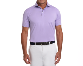 Man wearing The Anderson Shirt: Tudor, a short-sleeve polo with structured collar, paired with light trousers and a dark woven belt, showcasing a comfortable fit.