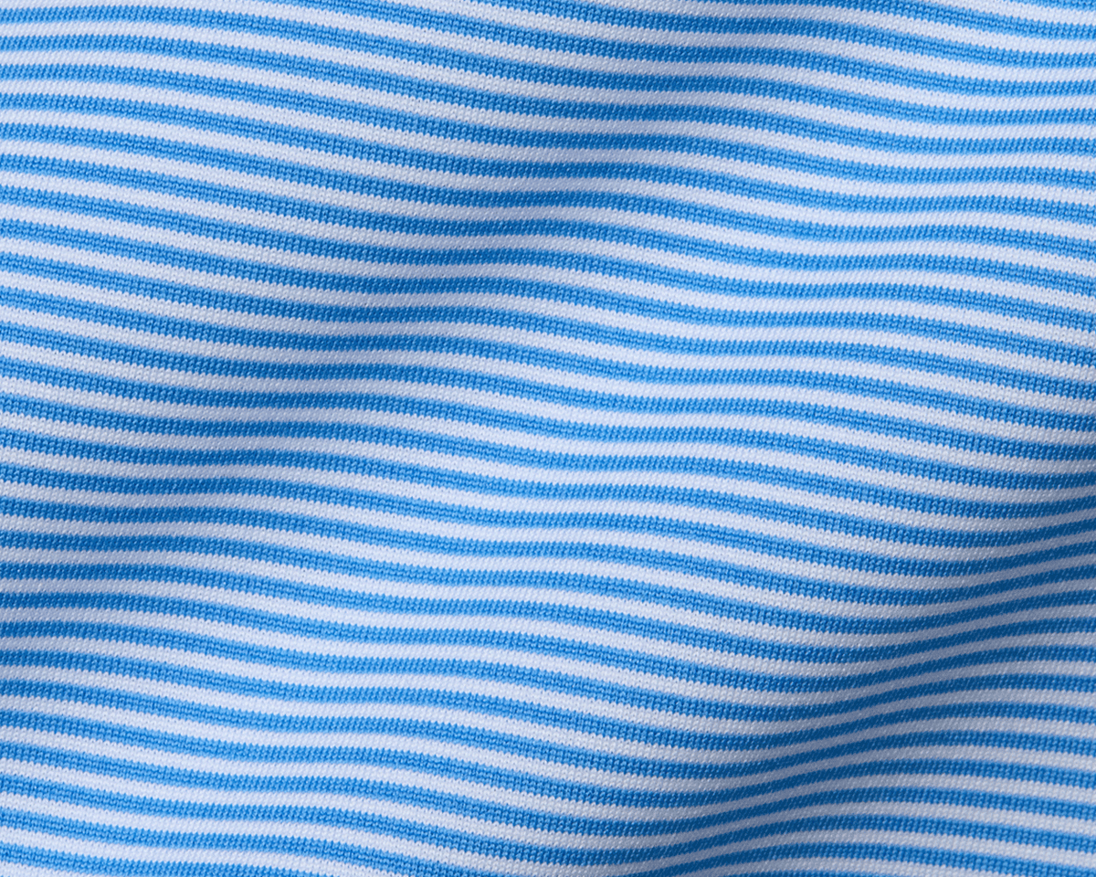 Close-up of The Perkins Boys Shirt: Horizon Blue & White, showcasing soft knit fabric with fine stripes, hinting at its breathable and moisture-wicking qualities.
