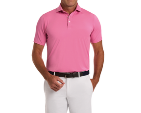 Man wearing The Anderson Shirt: Belmont, a short-sleeve polo with spread collar, tucked into light trousers, showcasing its jersey knit performance fabric and signature fit.