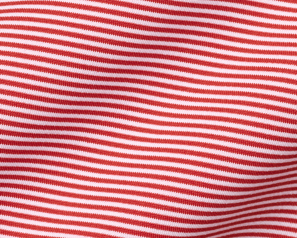 Close-up of The Perkins Shirt: Liberty Red & White, showcasing its fine knit, horizontal stripes, and gentle folds, highlighting its soft, performance fabric texture.