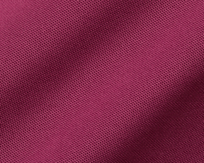Close-up of magenta knit fabric detailing the 2026 U.S. Open Macdonald Shirt: Cabernet, showcasing its breathable mesh texture and honeycomb pattern.