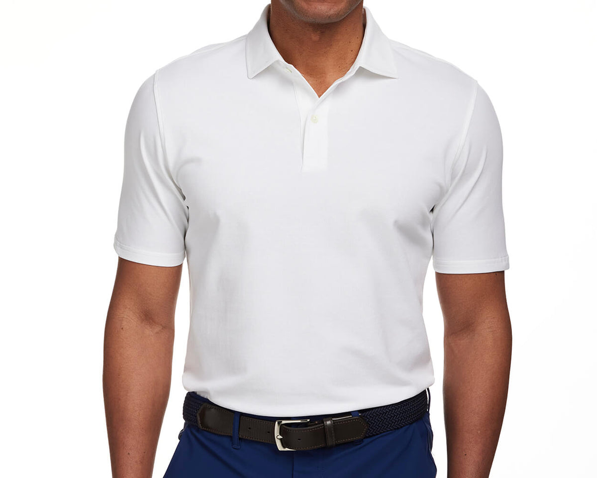 Front shot of Holderness and Bourne men's white polo shirt on man's torso.