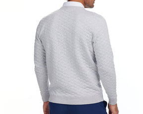 Back view of a man wearing the 2026 U.S. Open Ward Sweater in heathered gray, featuring a quilted-diamond pattern, ribbed cuffs, and hem.