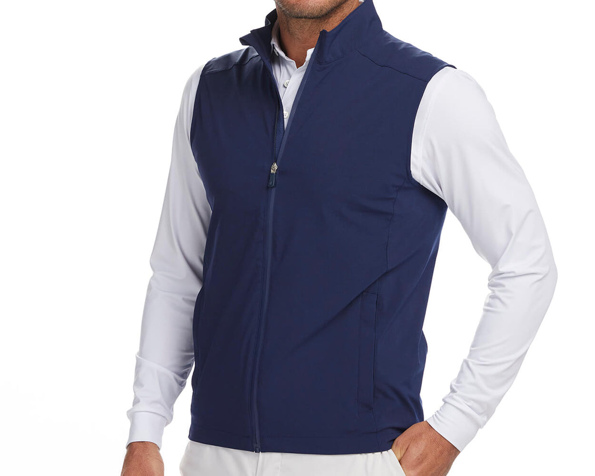 Front shot of Holderness and Bourne navy golf vest modeled on man's torso.