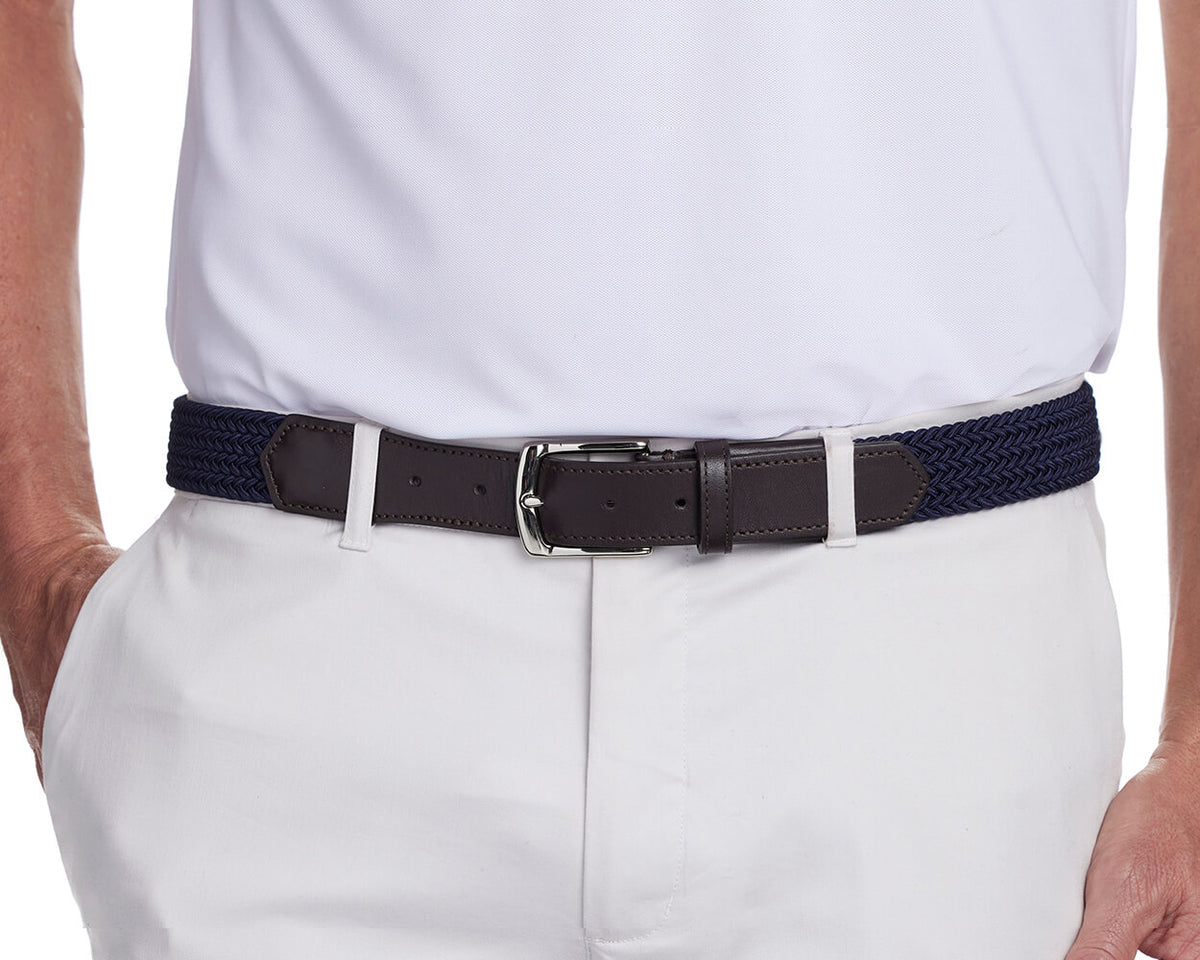 Navy woven belt from Holderness and Bourne modeled on man wearing all white.