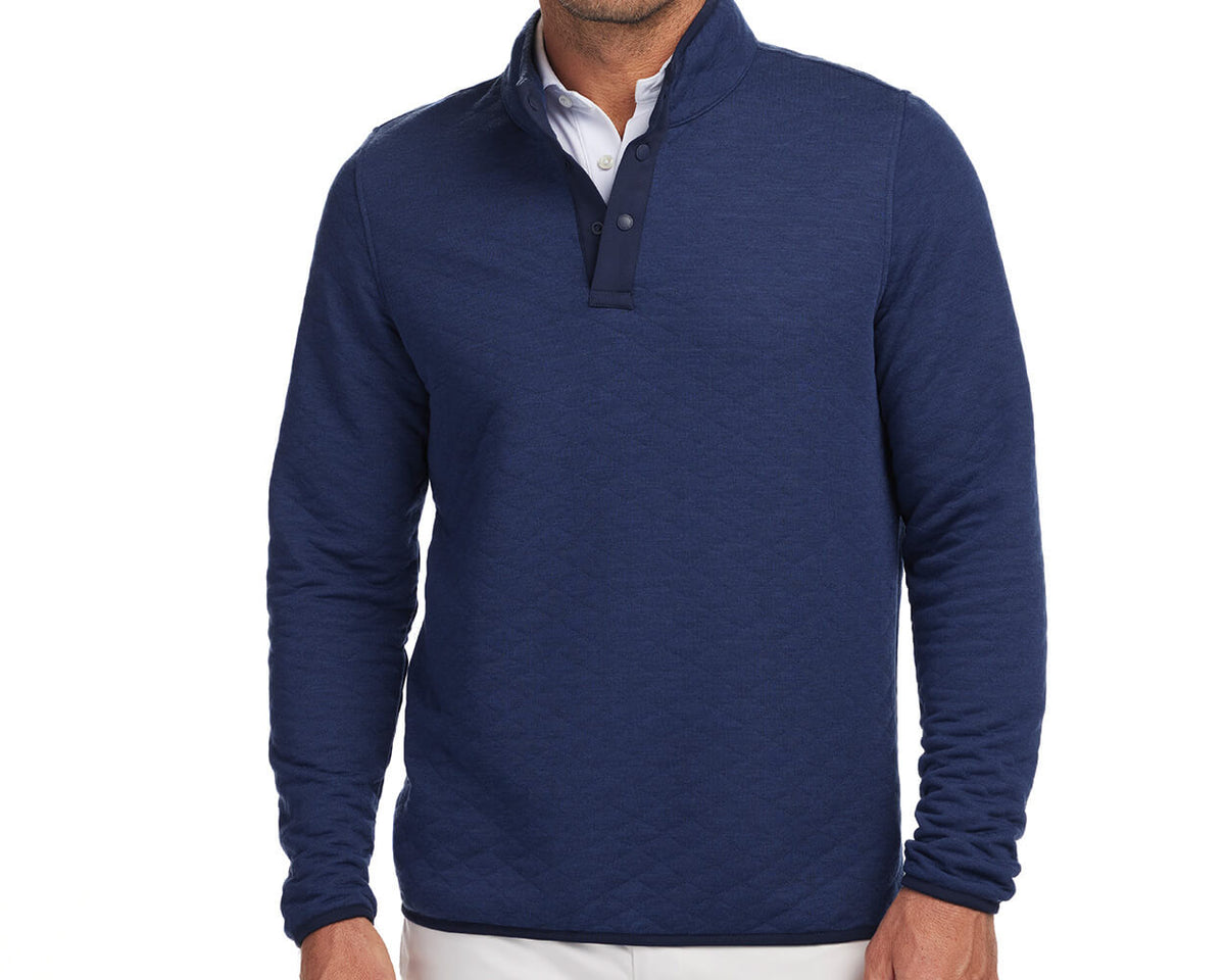 Front shot of Holderness and Bourne navy mens quilted pullover modeled on man's torso.
