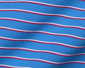 The Springer Shirt in Horizon Blue features a breathable knit fabric with red and white stripes, offering UPF 50+ protection and moisture wicking.