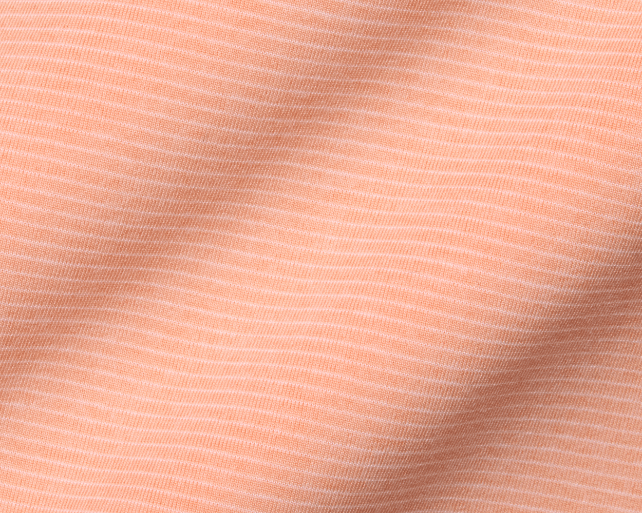 Close-up of The Holland Shirt: Heathered Nectarine, showcasing its soft knit fabric with fine horizontal pin-stripes, subtle texture, and gentle drape.