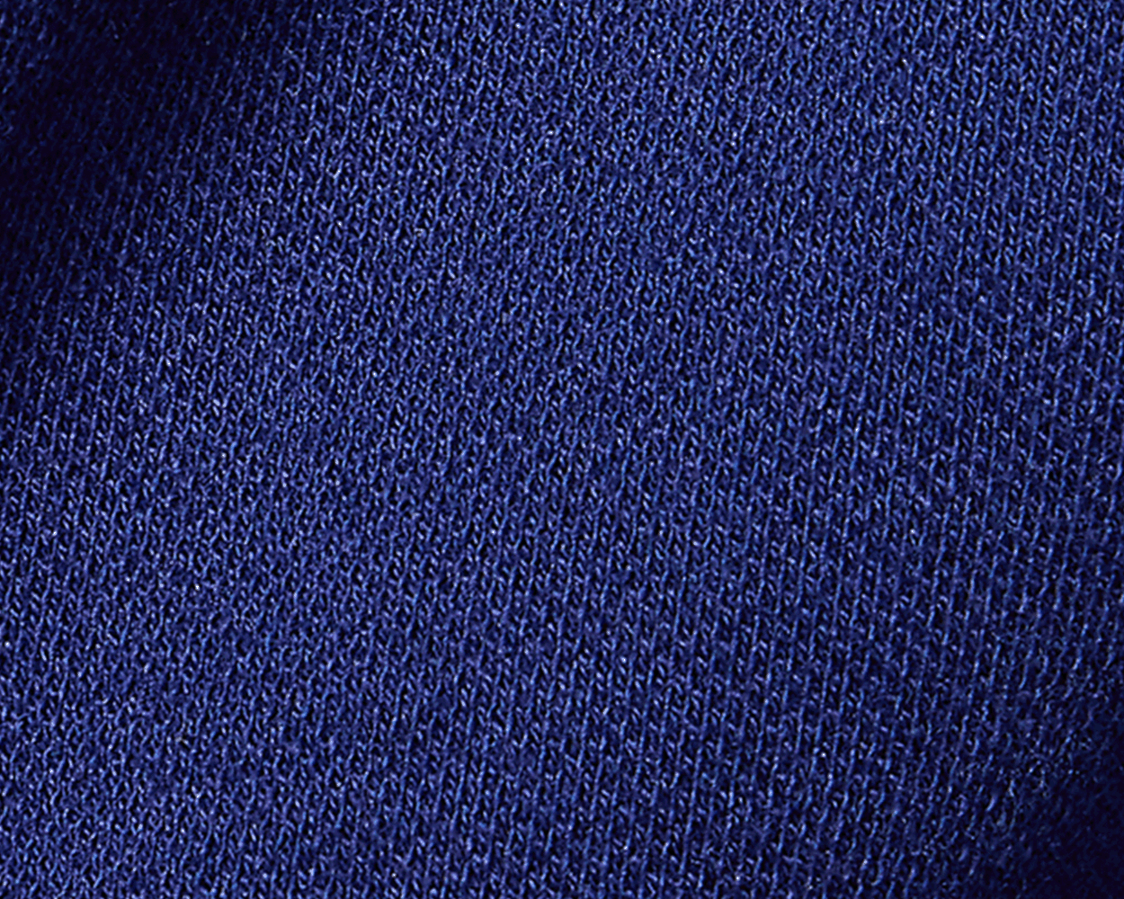 Close-up of the blue knit texture of the 2026 U.S. Open Neville Shirt, showcasing its intricate stitch pattern and soft, durable cotton-elastane blend.