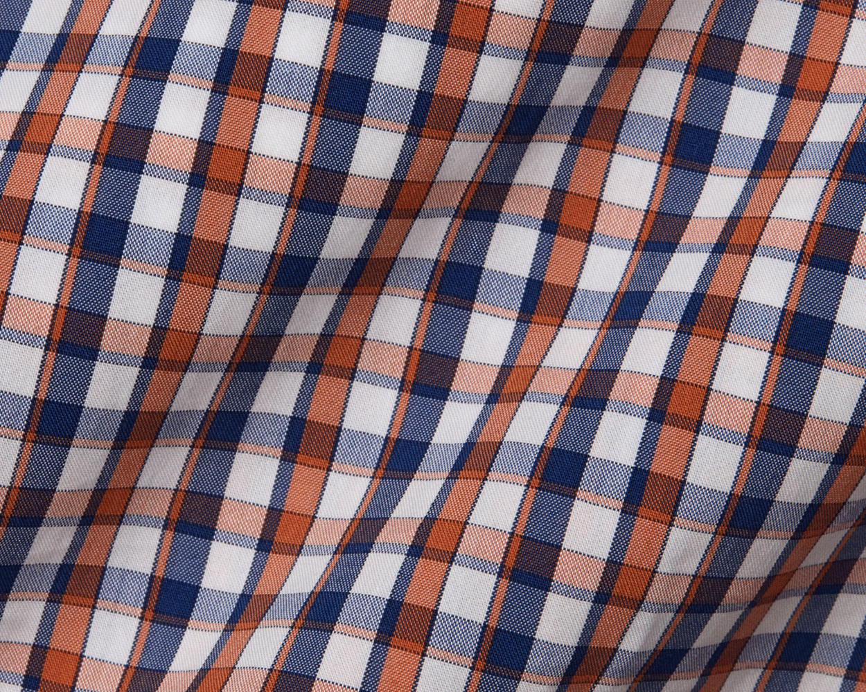 Close-up of plaid fabric with blue, orange, and white colors.