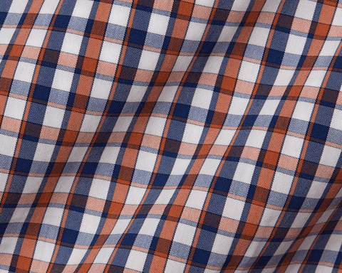 Close-up of plaid fabric with blue, orange, and white colors.
