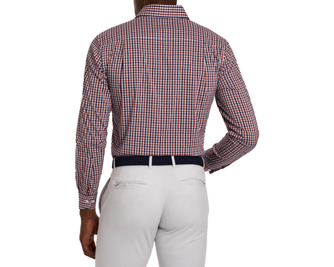 Man wearing a green and blue checkered shirt with white pants on a white background