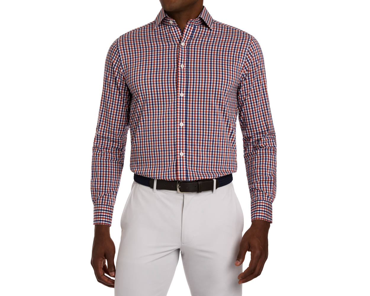 Man wearing an orange, white, and blue checkered shirt with white pants on a white background