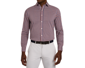 Man wearing an orange, white, and blue checkered shirt with white pants on a white background