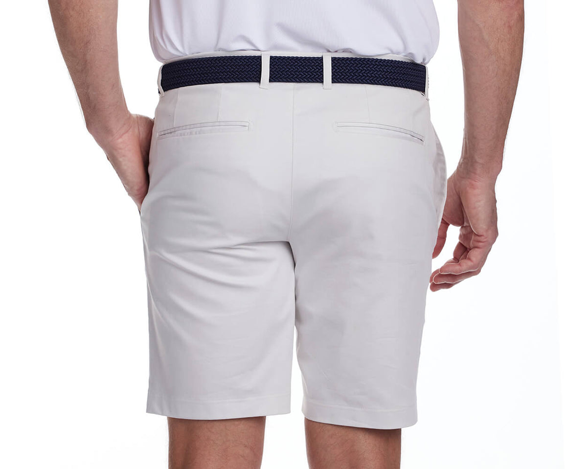 Back shot of Holderness and Bourne stone golf shorts modeled on man's legs.