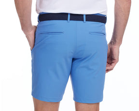 Back shot of Holderness and Bourne blue mens cotton golf shorts modeled on man's legs.