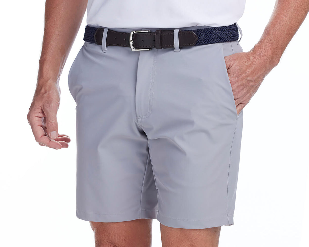 Front shot of Holderness and Bourne gray golf shorts modeled on man's legs.