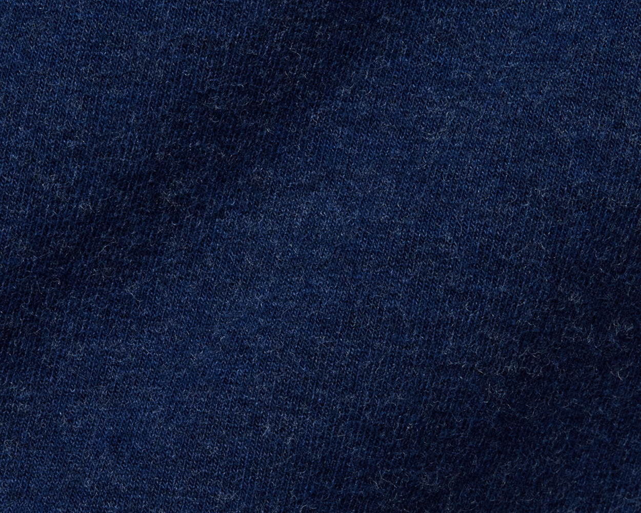 Close-up of The Lawson Hoodie: Heathered Atlantic, showcasing its tight-knit, dark-blue fabric texture, highlighting its ultra-soft, lint-speckled material.