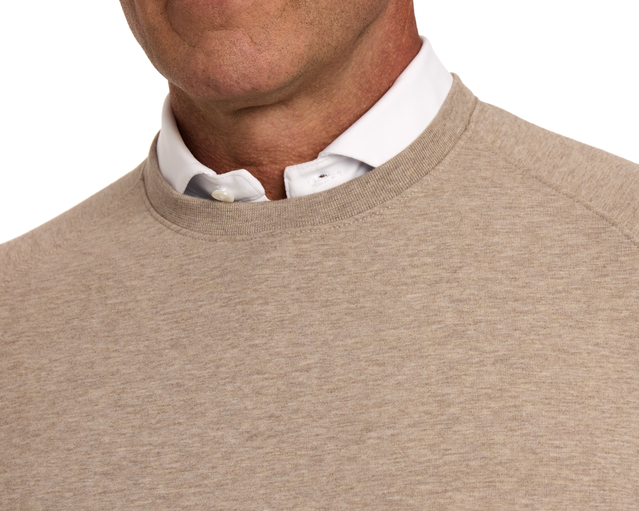 Person wearing The Kennedy Crewneck: Heathered Dune, showcasing its soft, comfortable cotton blend and plush terry interior over a white button-down shirt.